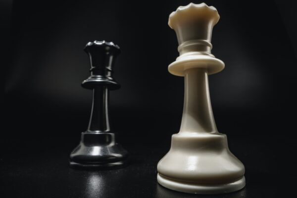 Chess game with chess pieces against black background