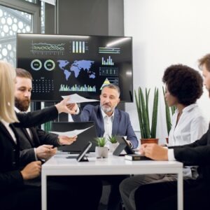 Diverse group of multiracial business people in the conference room with big TV screen, cooperating