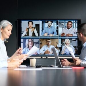 Global corporate video call in meeting room with diverse multiethnic people.